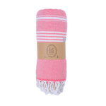 Pink towel with white stripes and fringes, branded 'La Ham', on a white background